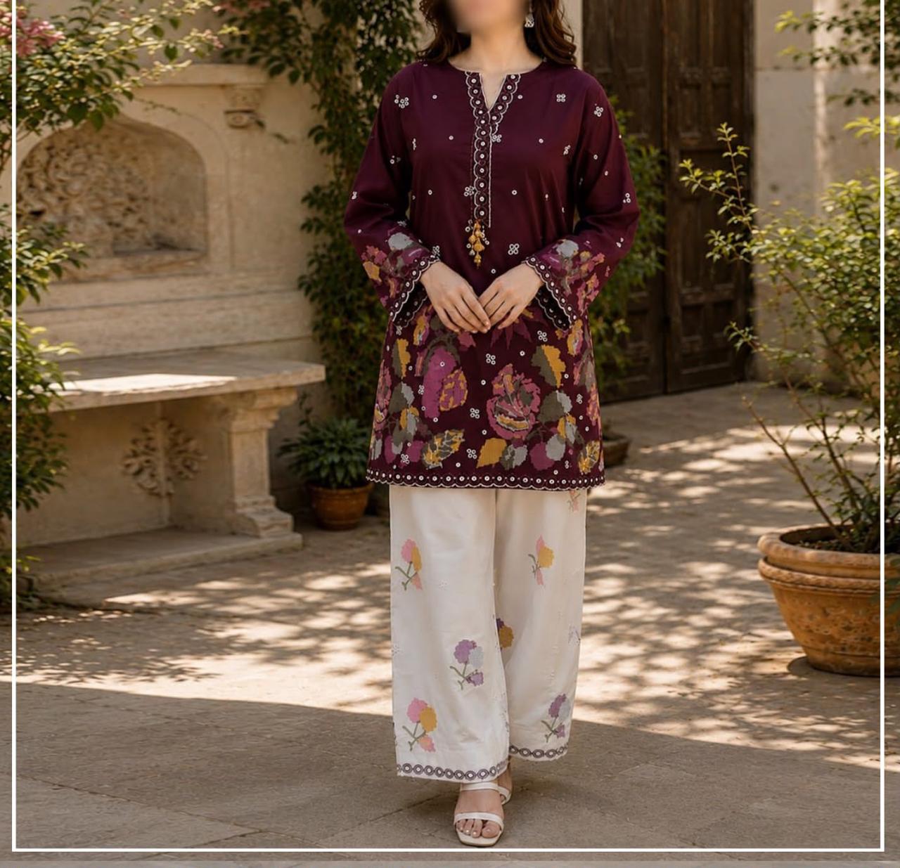 Traditional South Asian outfit featuring a deep maroon embroidered kurta with floral patterns and white wide-leg pants with colorful prints